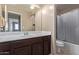 Bathroom with single vanity, shower/tub combo, and gray curtain at 39979 W Robbins Dr, Maricopa, AZ 85138