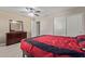 Bedroom with wood flooring, ceiling fan, and a red bed set at 39979 W Robbins Dr, Maricopa, AZ 85138