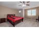 Bedroom with wood flooring, ceiling fan, and a red bed set at 39979 W Robbins Dr, Maricopa, AZ 85138