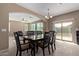 Dining room with table and chairs, open to the living area at 39979 W Robbins Dr, Maricopa, AZ 85138