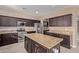 Modern kitchen with stainless steel appliances and granite island at 39979 W Robbins Dr, Maricopa, AZ 85138