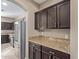 Kitchen features dark cabinets, granite counters and built-in appliances at 39979 W Robbins Dr, Maricopa, AZ 85138