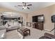 Living room with large TV and gray sofas at 39979 W Robbins Dr, Maricopa, AZ 85138