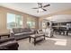 Living room with gray sofas and view of kitchen at 39979 W Robbins Dr, Maricopa, AZ 85138