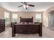 Main bedroom with a king-size bed and wood-look floors at 39979 W Robbins Dr, Maricopa, AZ 85138