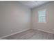 Bright bedroom with wood-look tile floors and plantation shutters at 4137 E Ronald St, Gilbert, AZ 85295