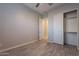 Well-lit bedroom with wood-look floors and ample closet space at 4137 E Ronald St, Gilbert, AZ 85295