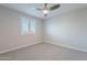 Well-lit bedroom with carpet flooring and ceiling fan at 4137 E Ronald St, Gilbert, AZ 85295