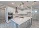 Modern kitchen with white cabinets, gray island, and herringbone backsplash at 4137 E Ronald St, Gilbert, AZ 85295