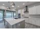 Modern kitchen with white cabinets, gray island, and herringbone backsplash at 4137 E Ronald St, Gilbert, AZ 85295