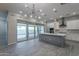 Modern kitchen with island, stainless steel appliances, and sliding doors to backyard at 4137 E Ronald St, Gilbert, AZ 85295