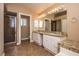 Double vanity bathroom with granite counters and shower at 4407 E Villa Theresa Dr, Phoenix, AZ 85032