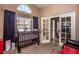 Bright Bedroom features a crib, large window, and access to another room at 4407 E Villa Theresa Dr, Phoenix, AZ 85032