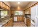 Well-equipped kitchen featuring granite countertops and wood cabinets at 4407 E Villa Theresa Dr, Phoenix, AZ 85032