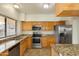 Galley kitchen with granite countertops and stainless steel appliances at 4407 E Villa Theresa Dr, Phoenix, AZ 85032