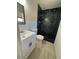 Updated bathroom features a walk-in shower with decorative tile and a modern vanity at 4854 W Berkeley Rd, Phoenix, AZ 85035