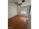 Cozy bedroom with hardwood floors, ceiling fan, and natural light from a large window at 4854 W Berkeley Rd, Phoenix, AZ 85035