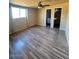 Bedroom with a ceiling fan, vinyl flooring and natural light creating a comfortable living space at 4854 W Berkeley Rd, Phoenix, AZ 85035