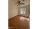 Bright bedroom with hardwood floors, ceiling fan, and window for natural light at 4854 W Berkeley Rd, Phoenix, AZ 85035