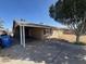 Single-story home with a covered parking area and neutral-toned stucco exterior, providing shade at 4854 W Berkeley Rd, Phoenix, AZ 85035