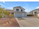 Two-story house with gray garage doors and a landscaped front yard at 5429 W Kerry Ln, Glendale, AZ 85308