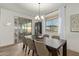 Dining room with a dark wood table, six chairs, and sliding glass doors at 5629 S Veneto --, Mesa, AZ 85212