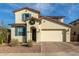 Two-story house with a tan facade, two-car garage, and landscaping at 5629 S Veneto --, Mesa, AZ 85212