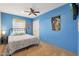 Cozy bedroom with blue walls, a queen-size bed, and ceiling fan at 5820 E Morning Vista Ln, Cave Creek, AZ 85331