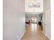 Bright hallway featuring light wood floors, chandelier, and an open view into the living room at 5820 E Morning Vista Ln, Cave Creek, AZ 85331