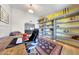 Open office with custom shelving, a desk area, and seamless flow into the adjacent room at 5820 E Morning Vista Ln, Cave Creek, AZ 85331
