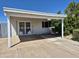 Sun-shaded carport area with grated doorway and mature landscaping for added privacy and appeal at 6126 W Earll Dr, Phoenix, AZ 85033