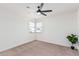 Bright bedroom with neutral walls, carpet, ceiling fan and window coverings at 6409 W Orange Dr, Glendale, AZ 85301