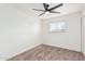 Bright bedroom with ceiling fan, closet, and neutral carpet at 6409 W Orange Dr, Glendale, AZ 85301