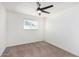 Well-lit bedroom with ceiling fan, window blinds, and neutral carpet at 6409 W Orange Dr, Glendale, AZ 85301