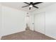 Simple bedroom with ceiling fan, window blinds, and neutral carpet at 6409 W Orange Dr, Glendale, AZ 85301