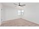 Well-lit bedroom with neutral carpeting and ceiling fan at 6409 W Orange Dr, Glendale, AZ 85301