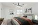 Serene bedroom featuring a plush bed with stylish linens, modern artwork, and ample natural light at 6409 W Orange Dr, Glendale, AZ 85301