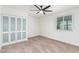 Bright bedroom with ceiling fan, window blinds, and neutral carpet at 6409 W Orange Dr, Glendale, AZ 85301