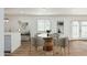 Bright dining area with a modern round table, stylish chairs, and ample natural light from a window and double doors at 6409 W Orange Dr, Glendale, AZ 85301