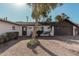 Single story home with a large driveway and mature trees at 6409 W Orange Dr, Glendale, AZ 85301