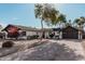 Single story home with a large driveway and mature trees at 6409 W Orange Dr, Glendale, AZ 85301