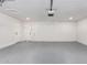 Garage with white walls, automatic garage door and extra storage at 6409 W Orange Dr, Glendale, AZ 85301