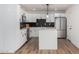 Modern kitchen with white cabinets, quartz countertops, and stainless steel appliances at 6409 W Orange Dr, Glendale, AZ 85301