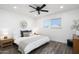 Bright bedroom with a king-size bed and wood-look floors at 725 E Vaughn Dr, Tempe, AZ 85283