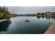 Serene lake view with a bird perched on a rock at 725 E Vaughn Dr, Tempe, AZ 85283