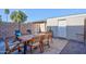 Relaxing patio with wooden dining set and storage shed at 725 E Vaughn Dr, Tempe, AZ 85283