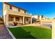 Large backyard with pool, artificial turf and two-story home at 7409 W Briles Rd, Peoria, AZ 85383