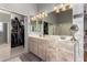 Double vanity bathroom with a large mirror and plenty of cabinet storage at 7409 W Briles Rd, Peoria, AZ 85383