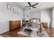 Bedroom with wood flooring, a queen bed, and plenty of natural light at 7409 W Briles Rd, Peoria, AZ 85383