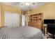 Bedroom with wood flooring, built-in shelving, and a desk area at 7409 W Briles Rd, Peoria, AZ 85383